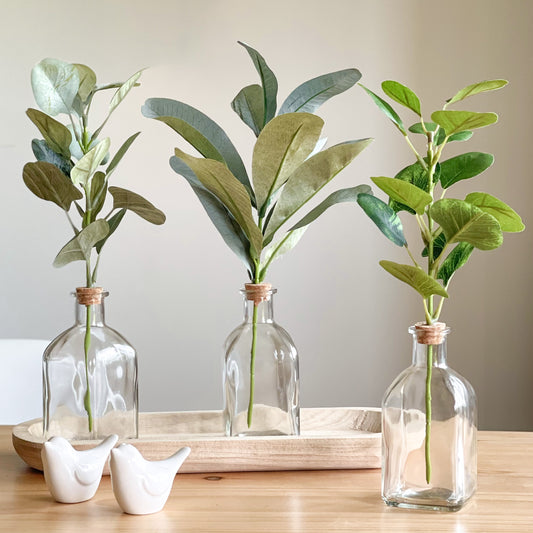 Home at no.7 Artificial stems in glass bottle vases
